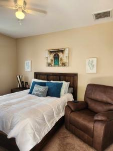 a bedroom with a large bed and a couch at Trilogy Polo Club - Casita in Indio