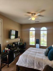 a bedroom with a bed and a ceiling fan at Trilogy Polo Club - Casita in Indio