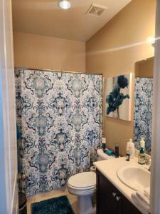 a bathroom with a toilet and a shower curtain at Trilogy Polo Club - Casita in Indio