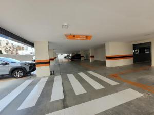 a parking lot with cars parked in a parking garage at Apto no Bessa 100 metros da praia in João Pessoa