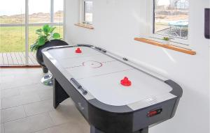 a ping pong table with two red hearts on it at Awesome Home In Haderslev With 4 Bedrooms, Sauna And Indoor Swimming Pool in Kelstrup