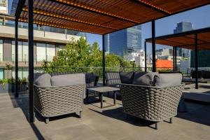 a patio with chairs and a table on a building at Urban Reforma Mexico City by Lumina in Mexico City