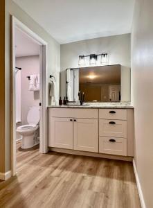 a bathroom with a sink and a toilet and a mirror at Wildflower Room 15 in Townsend