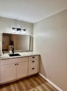 a kitchen with a sink and a mirror at Wildflower Room 15 in Townsend