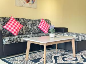 a living room with a couch and a coffee table at Desaru Private Beach Family Suite Big Pool D0513 in Bandar Penawar