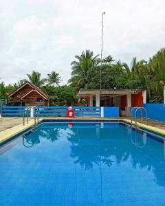 a large blue swimming pool in a resort at Lotus Sun & Waves Beach Resort in Baler