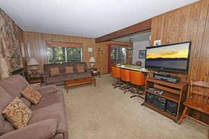 a living room with a couch and a flat screen tv at 1629 Pioneer Trail home in South Lake Tahoe