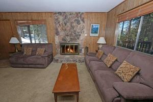 a living room with a couch and a fireplace at 1629 Pioneer Trail home in South Lake Tahoe
