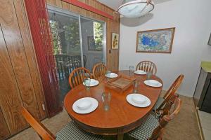 a dining room table with chairs and a wooden table at 1629 Pioneer Trail home in South Lake Tahoe