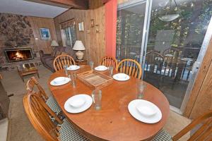 a wooden table with chairs and a dining room at 1629 Pioneer Trail home in South Lake Tahoe +13 photos