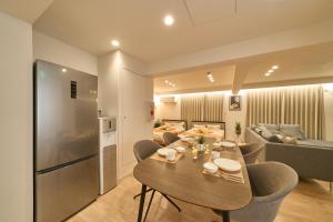 a kitchen and living room with a table and a couch at BETTEI in Oita