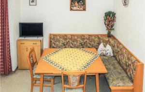 a living room with a table and a couch at Awesome Apartment In Aschau With 3 Bedrooms And Internet in Aschau