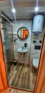 a small bathroom with a sink and a mirror at Rajska Rijeka in Foča