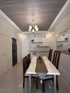 a kitchen with a dining room table and chairs at Japandi Home A - Fully Aircon, WIFI, Hot shower, 24hGuard, Center, near Malls in General Santos +19 photos