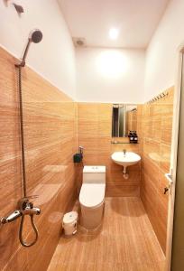 a bathroom with a toilet and a sink at Ohayou Dalat Homestay in Da Lat