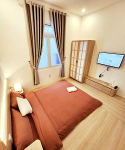 a bedroom with a large bed with a large window at Ohayou Dalat Homestay in Da Lat +15 photos