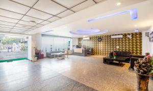 an office lobby with a couch and a table at Treebo Trend White Rock - Sohna Road in Gurgaon