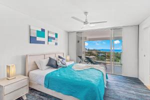 a bedroom with a bed and a large window at Coral View at Azure Sea in Airlie Beach