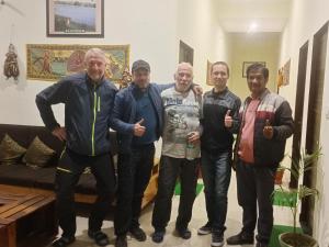 a group of men posing for a picture in a living room at The Vantage Haveli in Sawāi Mādhopur