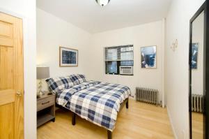 a bedroom with a bed and a dresser and a window at 102-1A Best Value 2BR Apt Near Central Park in New York