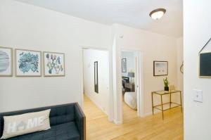a living room with a couch and a hallway at 102-1A Best Value 2BR Apt Near Central Park in New York