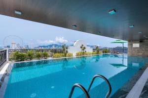 a large swimming pool on the roof of a building at Florence Hotel in Danang