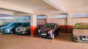 three parked cars parked in a garage at Hotel Nawab's in Karīmnagar