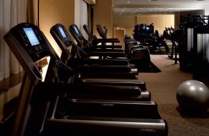 a row of exercise bikes lined up in a gym at The Ritz-Carlton, Tokyo in Tokyo