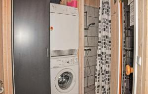 Waschmaschine und Trockner in einem kleinen Bad in der Unterkunft Cozy Home In Sydals With Sauna in Skovby