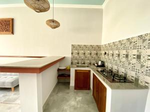 a kitchen with a sink and a counter top at Kanitri Villas Seminyak by MERE in Seminyak