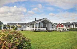 a house with a large lawn in front of it at Holiday Home Bellevue Iii in Skovby +19 photos