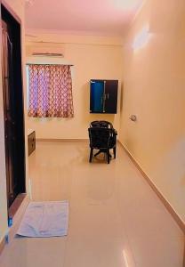 a living room with a table and a window at Hotel Nawab's in Karīmnagar