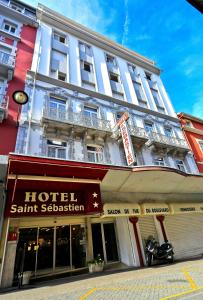 un hôtel avec un panneau devant un bâtiment dans l'établissement Hôtel Saint Sébastien, à Lourdes