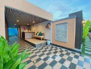 a house with a checkered floor and a patio at Kanitri Villas Seminyak by MERE in Seminyak