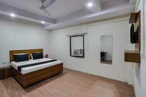 sypialnia z łóżkiem i telewizorem w obiekcie OYO Lotus Inn w Nowym Delhi
