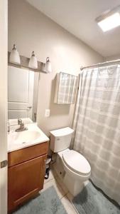 a bathroom with a toilet and a sink and a shower at Entire Home in North Potomac in Potomac