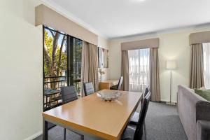 a living room with a table and a couch at Northbridge Prime Location*2BR in Perth