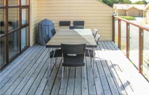 a wooden deck with a table and chairs on it at Lovely Home In Egernsund With Wifi in Egernsund