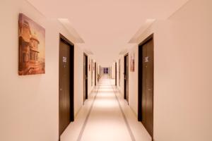 a hallway of a building with doors and a long corridor at Keys Select by Lemon Tree Hotels, Udaipur in Udaipur