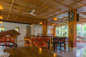 a dining room with wooden tables and chairs at GRAND OCEANUS RESORT in Beadonābād