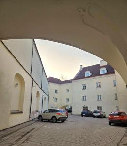 a car parked in a parking lot next to a building at Domus Maria in Vilnius