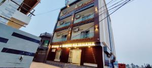 a building with a sign on the side of it at Goroomgo Shree Gajanana Puri Near Sea Beach - Lift Facilities - Best Selling in Puri