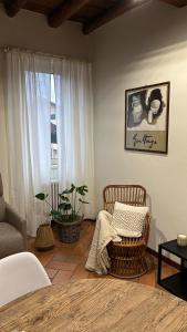 a living room with a chair and a window at CASA DI MILO in Cernobbio
