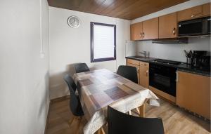 a kitchen with a table and chairs in a room at Amazing Home In Oberelbert With 2 Bedrooms in Oberelbert