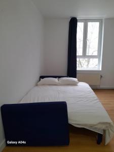 een groot bed in een kamer met een raam bij The Boulevard Apartment in Brussel