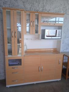 a large wooden cabinet with glass doors and pulls at HOSPEDAJE PARACAS SUR in Paracas
