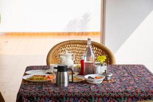 a table with food and a bottle on it at Girisadan Boutique Hotel in Jaipur