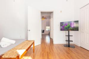 a living room with a couch and a flat screen tv at 1-BDRM Apartment with Balcony - Heart of Downtown and Wynwood in Miami