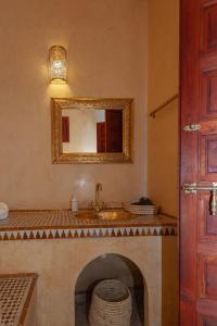 a bathroom with a sink and a mirror at Riad Amalia in Marrakech