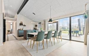 a kitchen and dining room with a table and chairs at 4 Bedroom Gorgeous Home In Glesborg in Glesborg